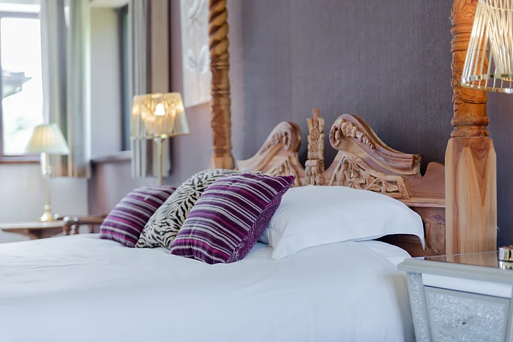 bed with purple pillows