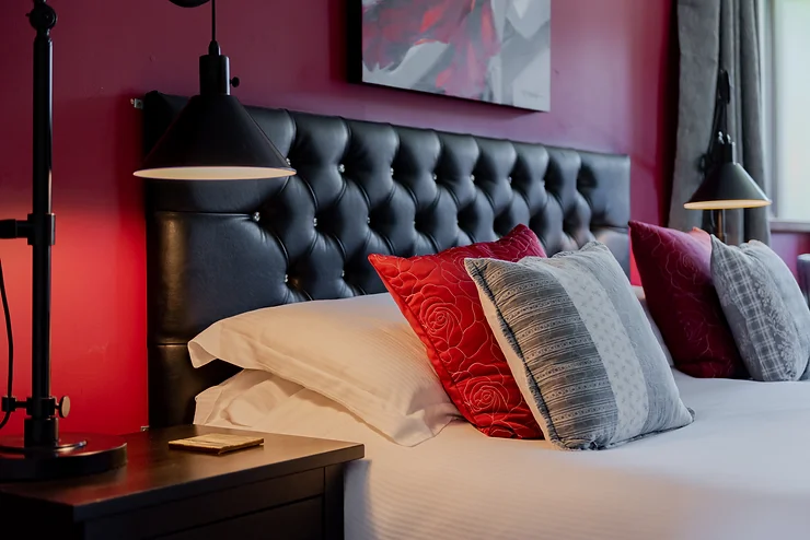 bedroom with red wall and red pillows